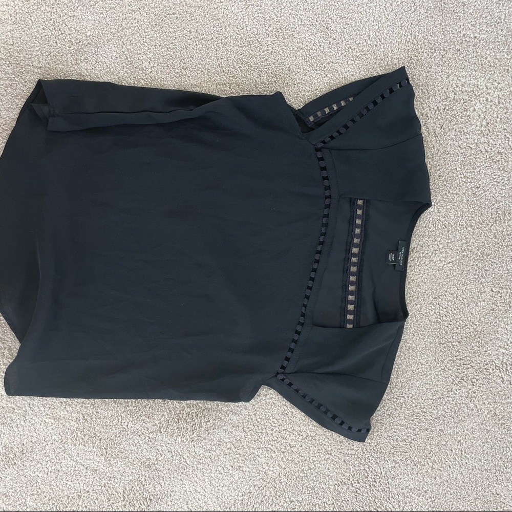 Ann Taylor black bouse with beautiful details around the neck.